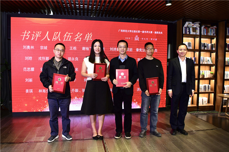 廣西師范大學出版社集團黨委副書記、總編輯湯文輝（右一）為書評人代表頒發(fā)聘書（李顯楊攝）.jpg